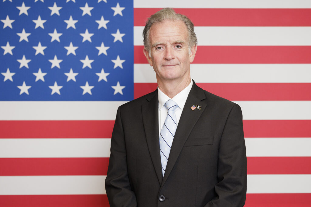 Walt Piatt stands in front of U.S. flag inside Wounded Warrior Project’s Washington, DC office.